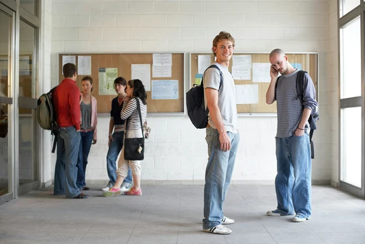 A group of students standing in a hallway